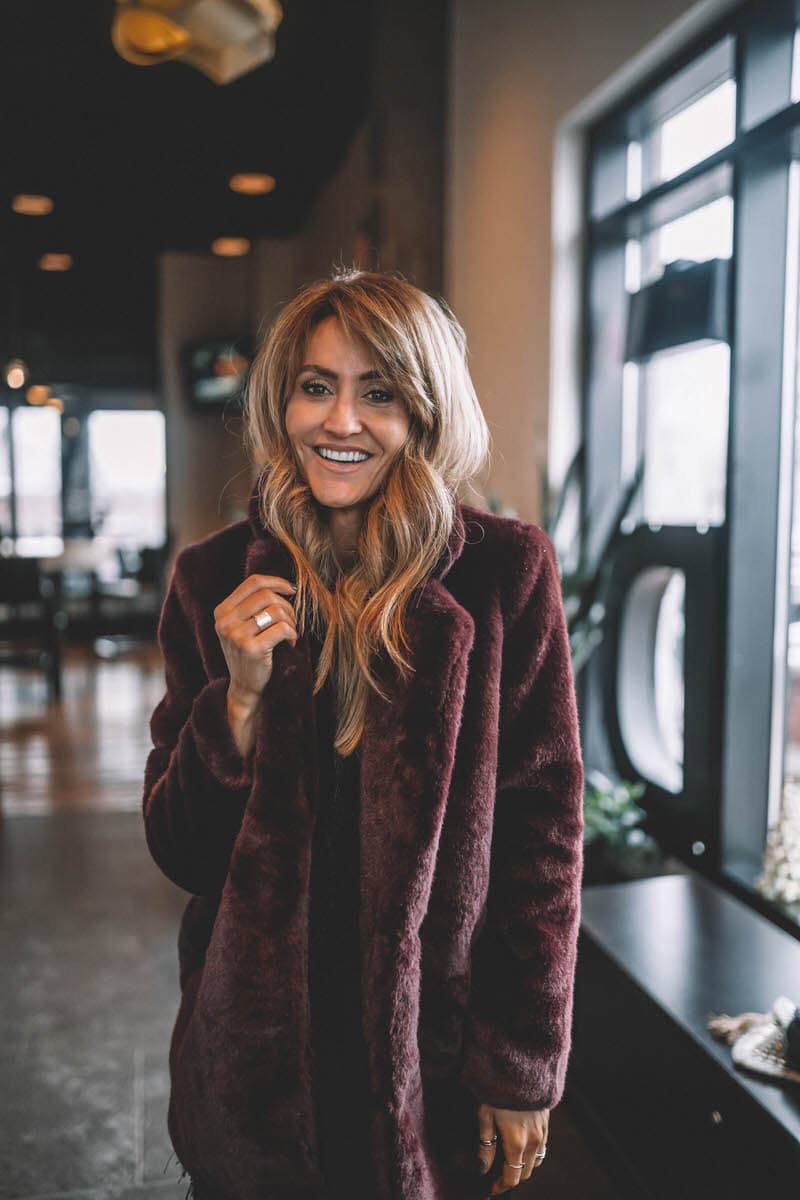 Black Fringe Dress and Fur Coat | Holiday Party look featured by top Indianapolis fashion blogger, Karina Style Diaries: image of a woman wearing a Lesley Jane black fringe dress, Manolo Blahnik heels, Chanel bubble bag, Daniel Wellington watch and Jemma Sands drop earrings