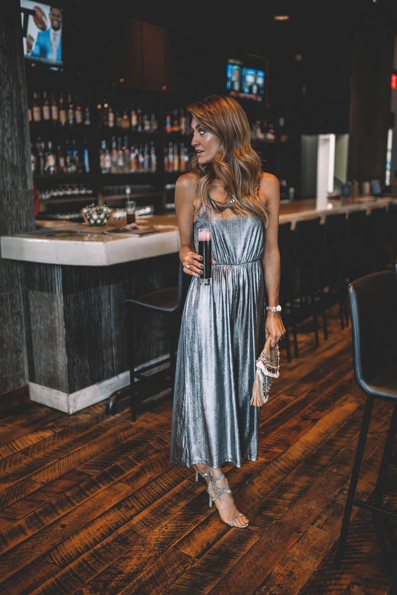 Top Indianapolis fashion blogger, Karina Style Diaries, features the perfect Holiday look with a BB Dakota metallic Jumpsuit: image of a blonde woman wearing a BB Dakota metallic jumpsuit, a BB Dakota faux fur coat, a Sashi clutch and Manolo Blahnik silver heels