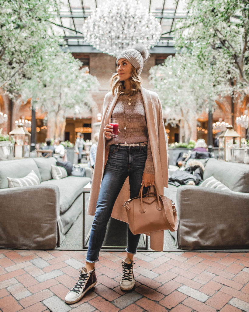 Somethings navy sweater | pompom beanie | 3 arts café | layers necklace | givenchy antigona pink beige Weekly outfit recap featured by top US fashion blogger, Karina Style Diaries: image of a woman wearing a winter hat faux fur pom beanie, striped pullover, Goodnight macaroon striped cardigan, Golden Goose sneakers and Givenchy bag