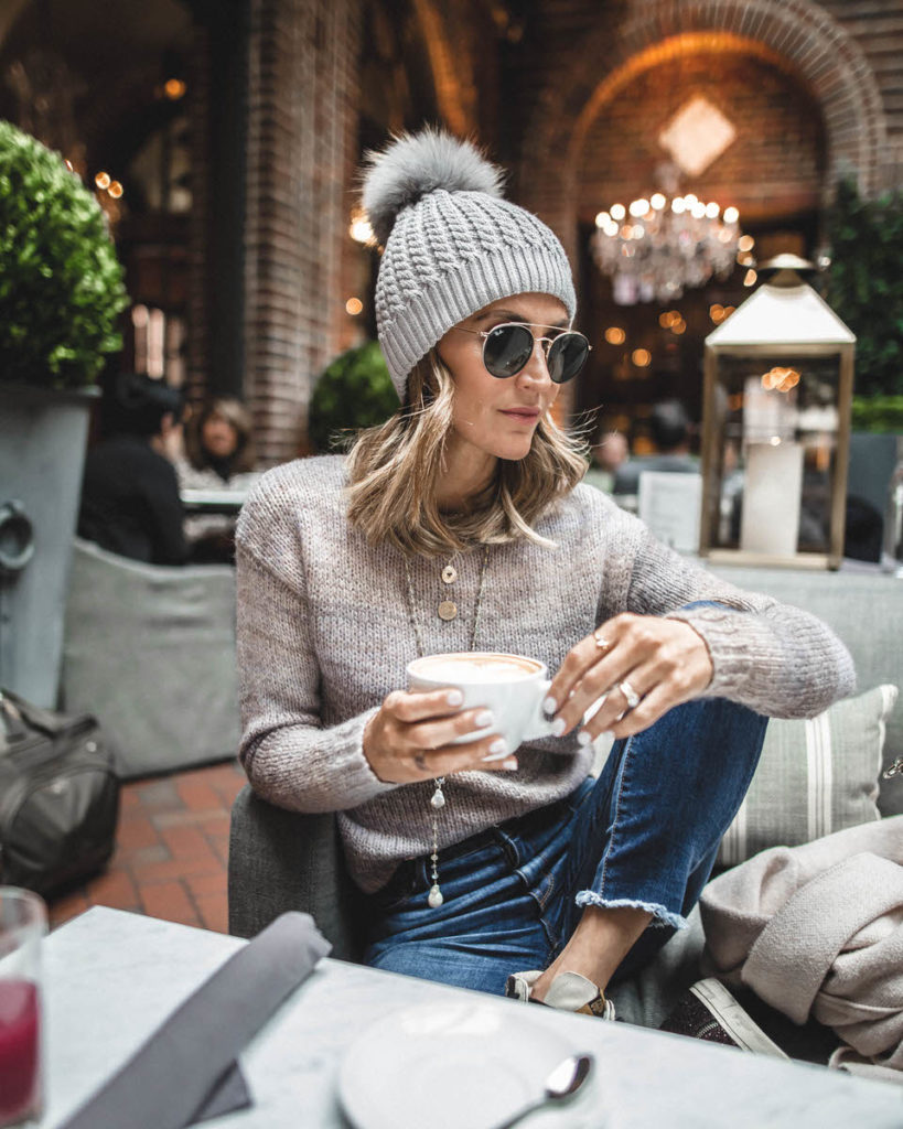 Somethings navy sweater | pompom beanie | 3 arts café | layers necklace | Weekly outfit recap featured by top US fashion blogger, Karina Style Diaries: image of a woman wearing a winter hat faux fur pom beanie, striped pullover, Goodnight macaroon striped cardigan, Golden Goose sneakers and Givenchy bag