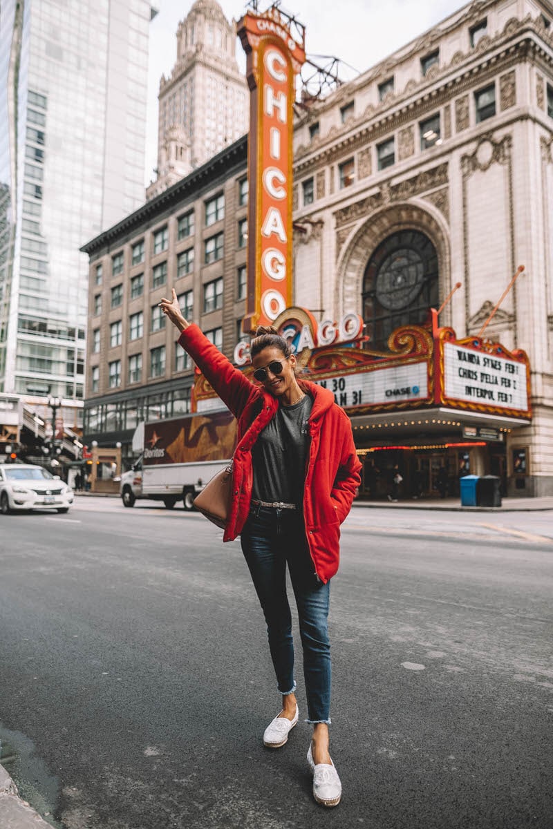 Chicago Theater | Karina Style Diaries | Red puffer Jacket | skinny jeans | chanel espadrilles | Givenchy Antigona | Something Navy red puffer jacket styled by top US fashion blogger, Karina Style Diaries: image of a woman wearing a red puffer jacket, Grace & Grace t-shirt, Good American skinny jeans, Chanel espadrilles, Givenchy small antigona, Ray-Ban aviator sunglasses