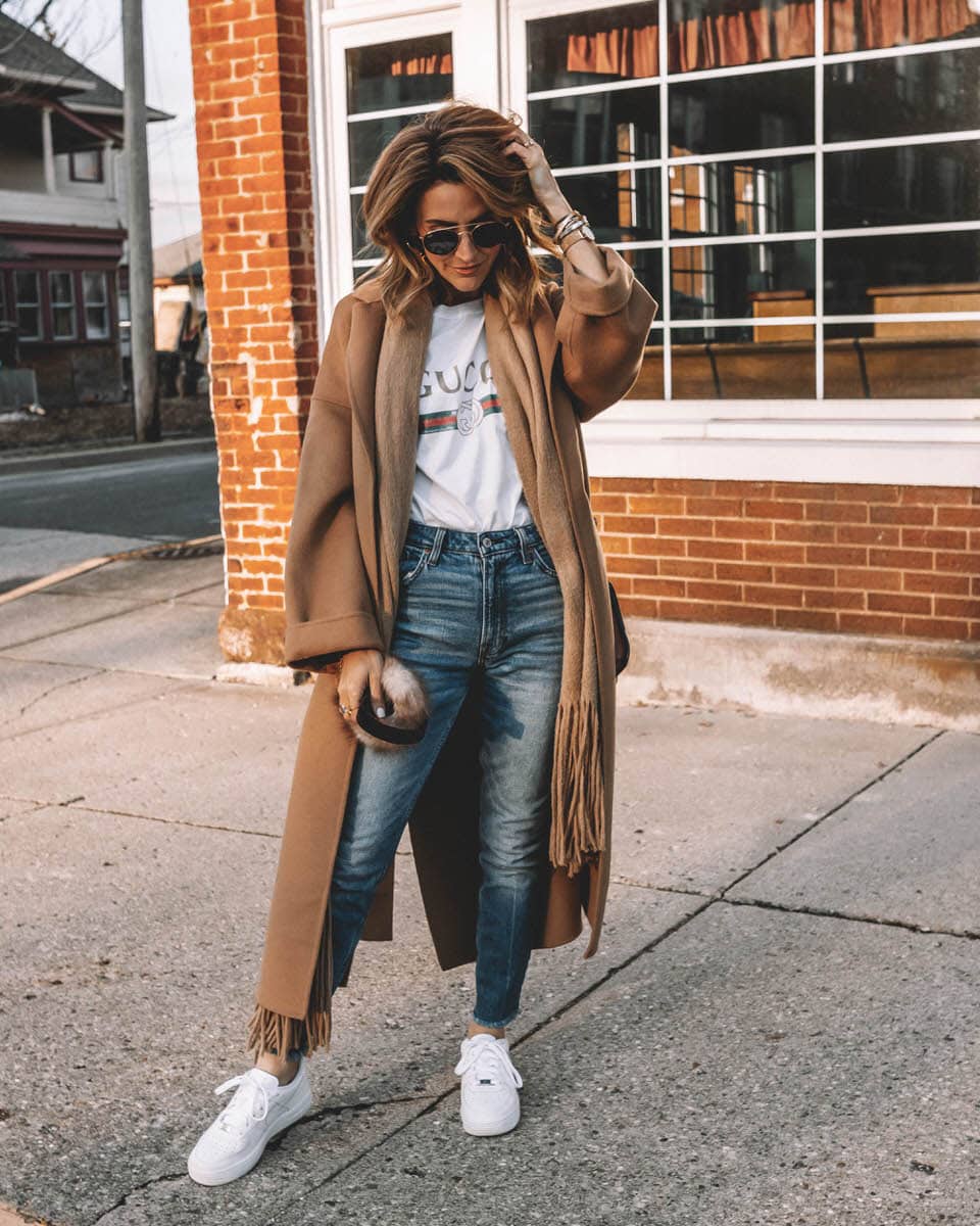 Fashion Blogger Karina Reske wears Camel Coat | Gucci t-shirt | nike air force 1 white | fur earmuffs | round ray bans | Zara camel coat styled by top US fashion blogger, Karina Style Diaries: image of a woman wearing an oversized Zara camel coat, distressed Gucci tee, Abercrombie and Fitch high waisted jeans, Nike Air Force 1 sneakers, Ray Ban aviator sunglasses, faux fur earmuffs and Chloe leather shoulder bag