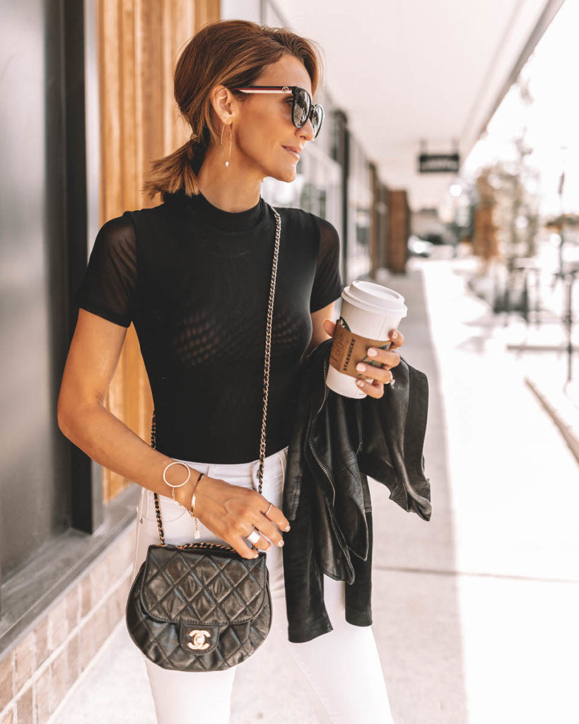 Karina Reske wearing white skinny jeans black bodysuit chanle buble crossbody leopard shoes pointy flats leather suede moto jacket black and white chic outfit idea