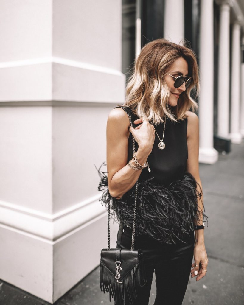 Karina Style Diaries wearing Farfetch feather top all black outfit coated high waist jeans Tamara Mellon Black heels YSL fringe bag NYFW outfit