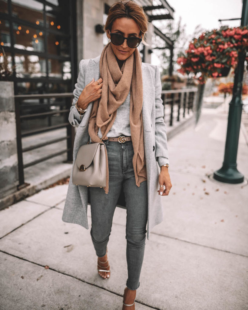 Karina Style Diaries wearing structured grey coat camel cashmere scarf grey skinny jeans gucci belt Polene Numero Un mini grey silver strappy sandals