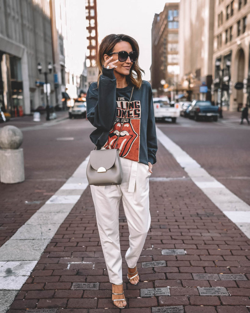 Karina Style Diaries wearing Rolling Stones sweatshirt high waist trousers strappy heeled sandals Polene Numero Un Mini grey outfit