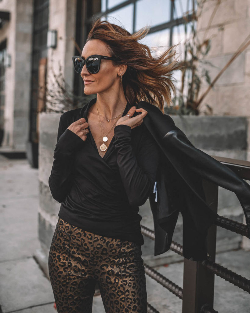 Karina Style Diaries wearing black long sleeve top gold leopard print pants work holiday outfit