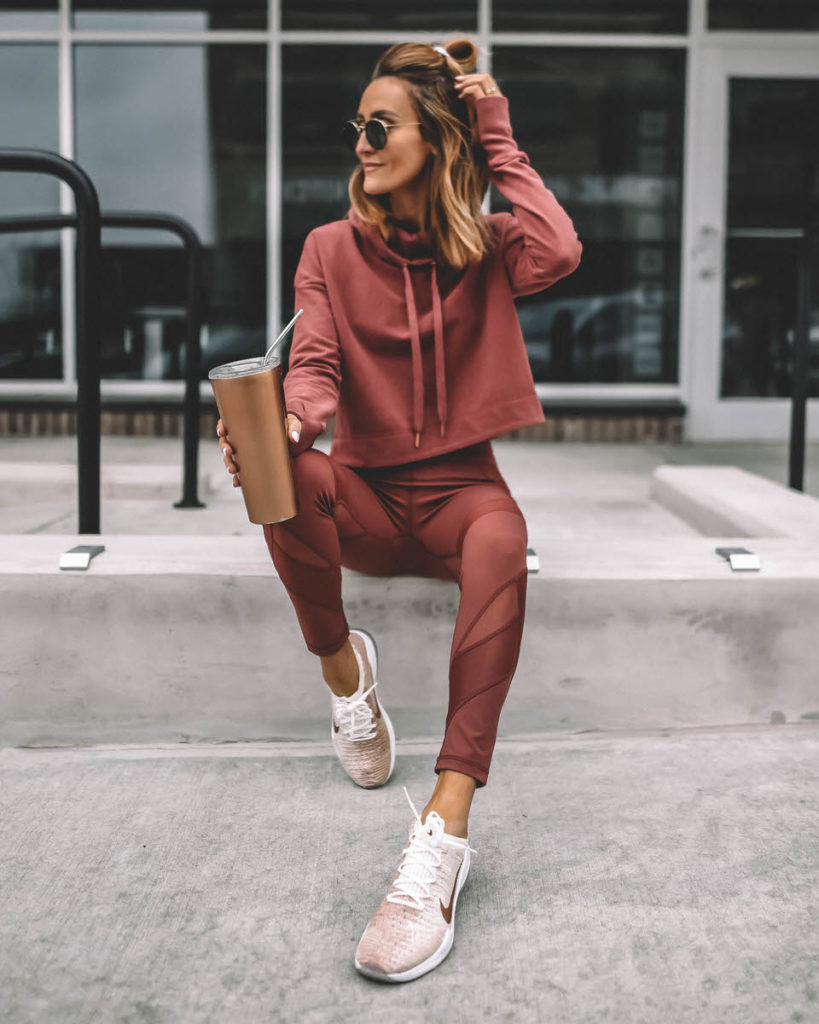 Lifestyle Blogger Karina Reske wearing Athletic set Sweaty Betty rust leggings and hoodie