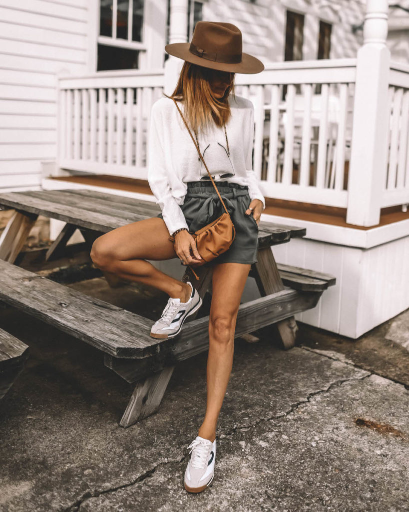 Karina Style Diaries wearing sage paperbag shorts tretorn sneakers western hat dolman sleeve white sweater spring outfit