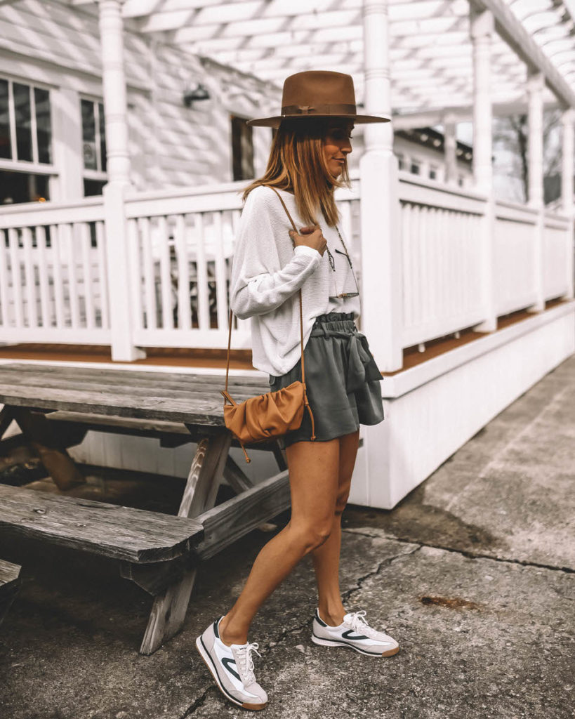 Karina Style Diaries wearing sage paperbag shorts tretorn sneakers western hat dolman sleeve white sweater spring outfit