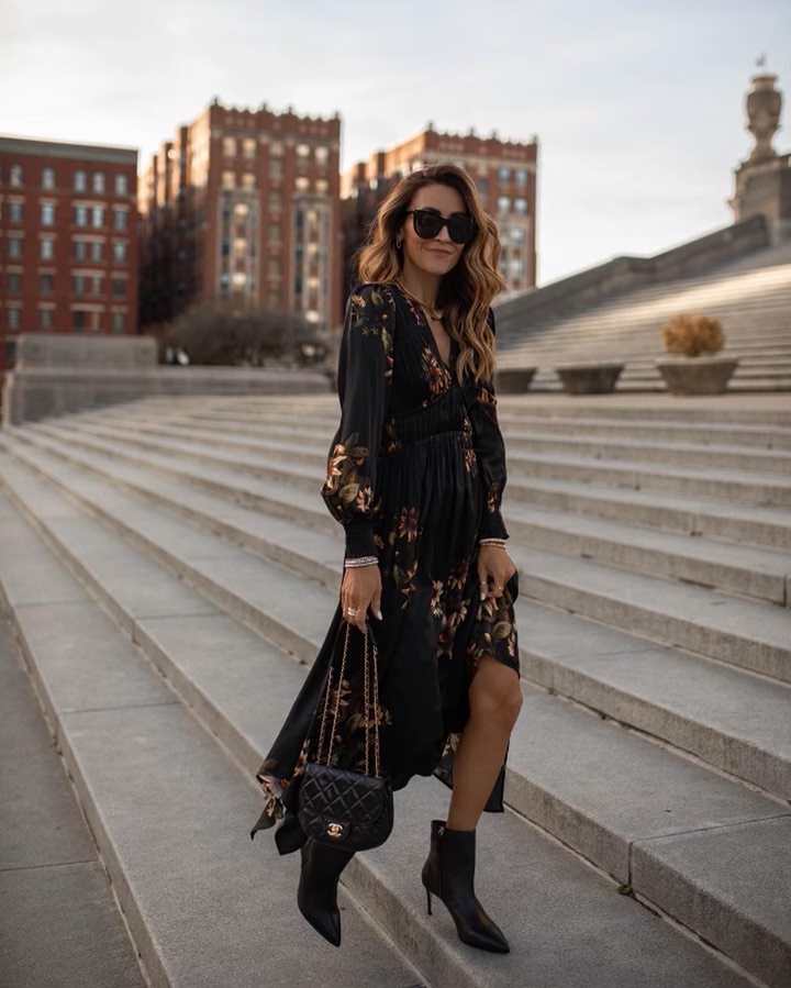 Karina wears black silk all saints dress with schutz high heel bootie and chanel bag