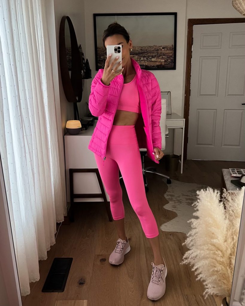 karina wears pink amazon workout set with pink puffer jacket