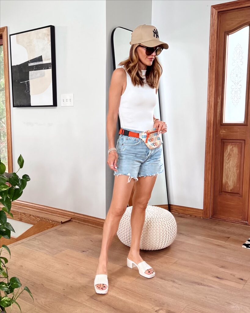 Karina wears agolde denim shorts with body suit and gucci belt bag and gucci slides