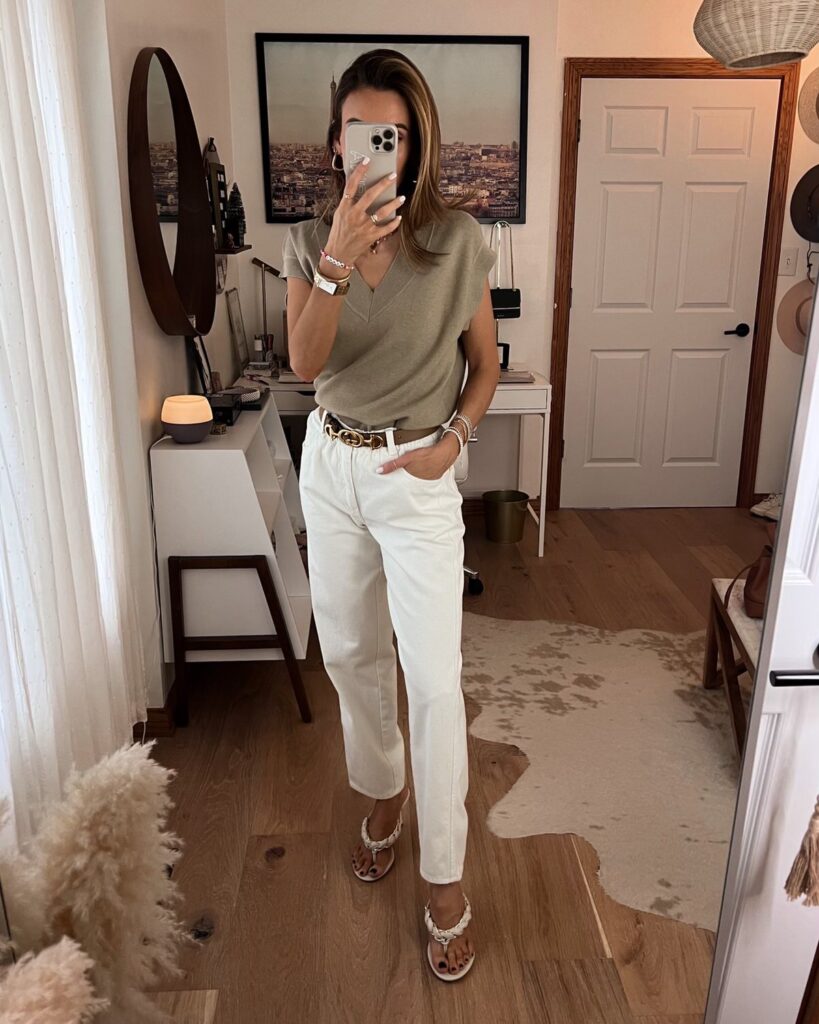 Karina wears amazon white paperbag pants with v neck sweater vest