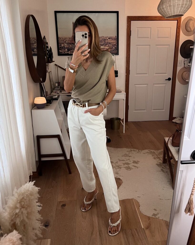 Karina wears amazon white paperbag pants with v neck sweater vest