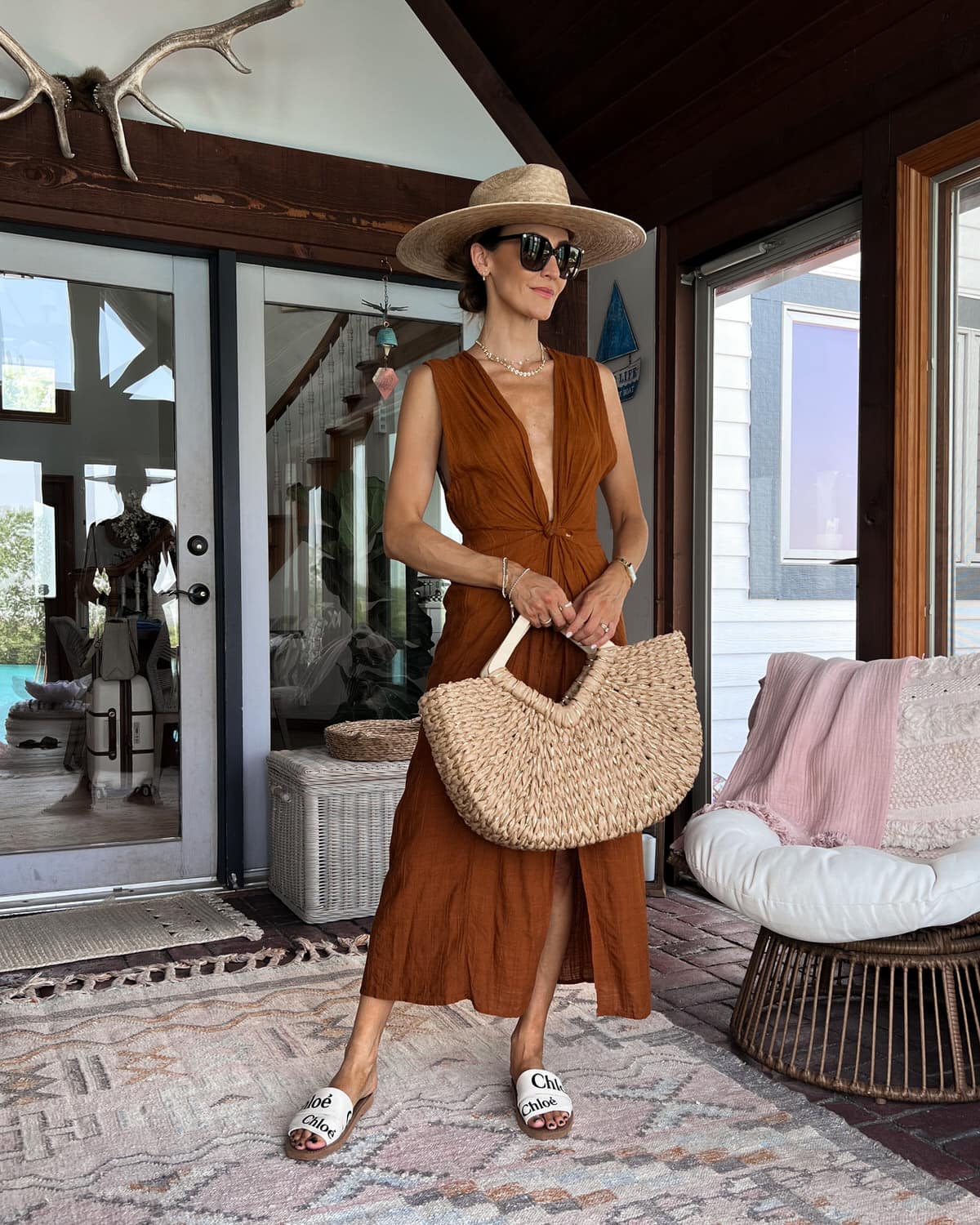 karina wears l space bathing suit cover up with lack of color sun hat