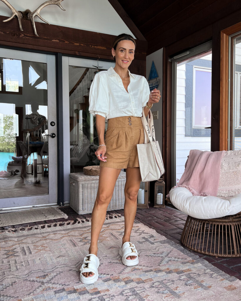 karina wears veronica beard shorts with puff sleeve linen top