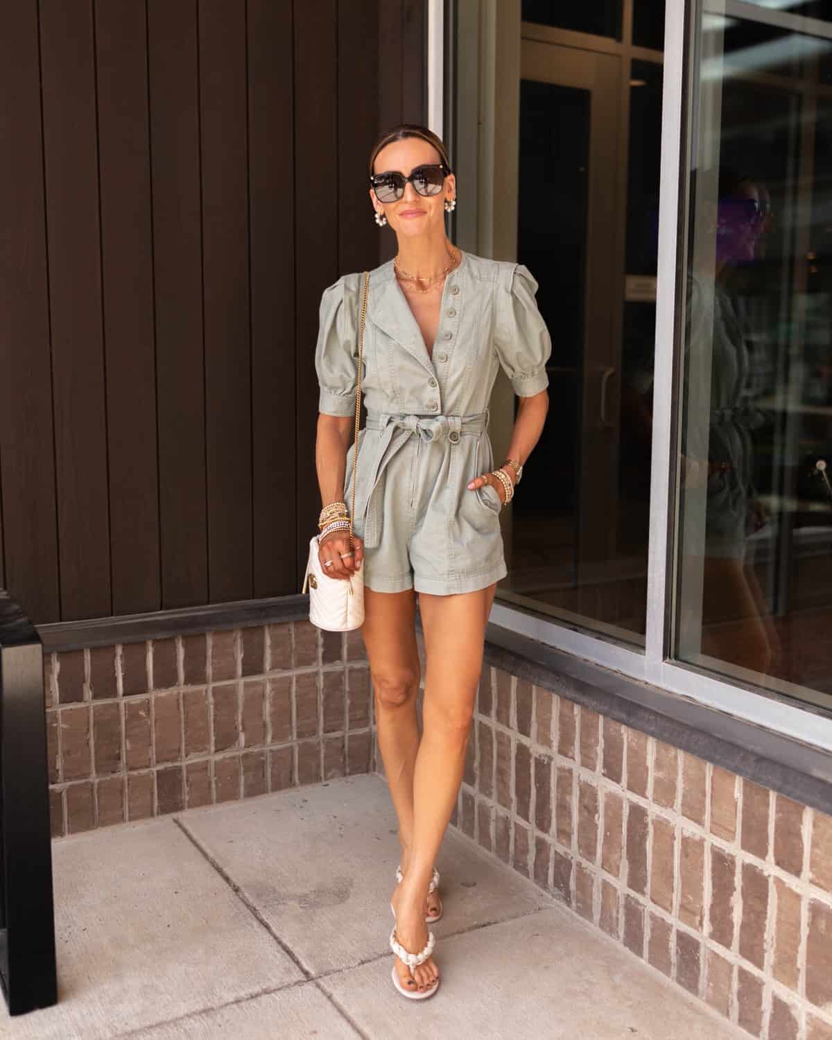 karina wears ulla johnson light green denim playsuit