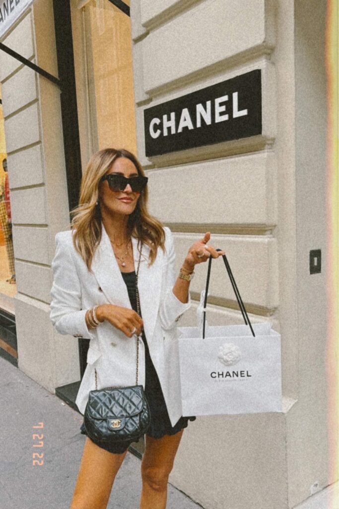 karina wears chanel handbag and white blazer with isabel marant skirt