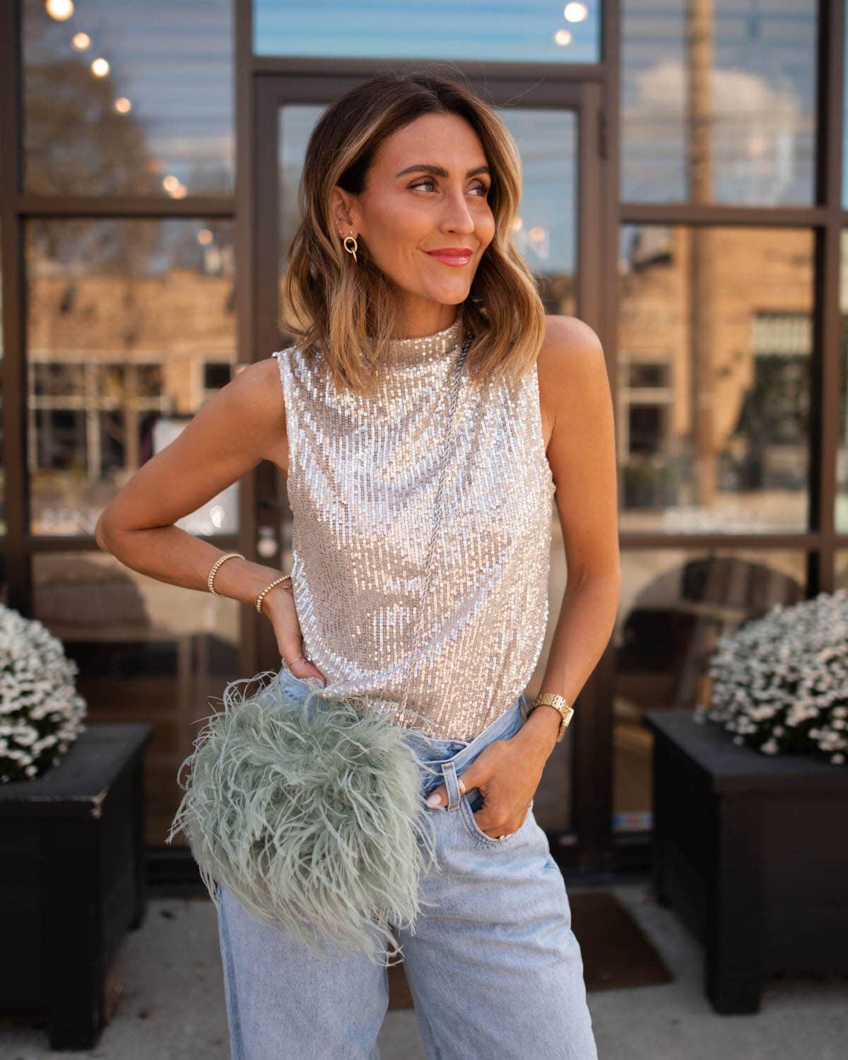 Karina wears Nordstrom sequin top with agolde criss cross jeans