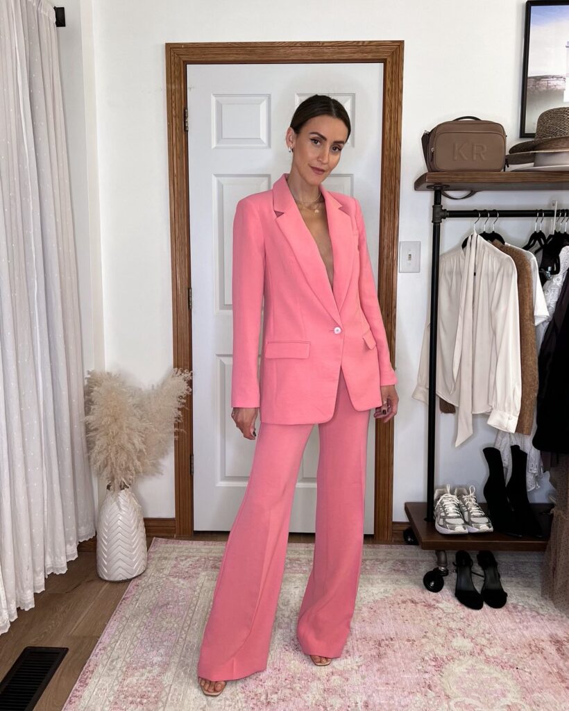 Karina wears Express pink twill suit