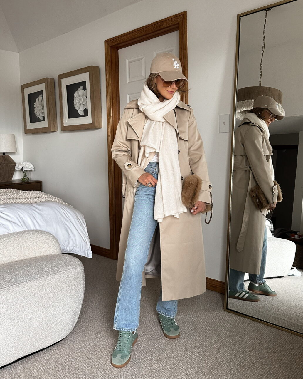 jeans with samba sneakers and a cardigan, coat, wrap scarf, and baseball cap