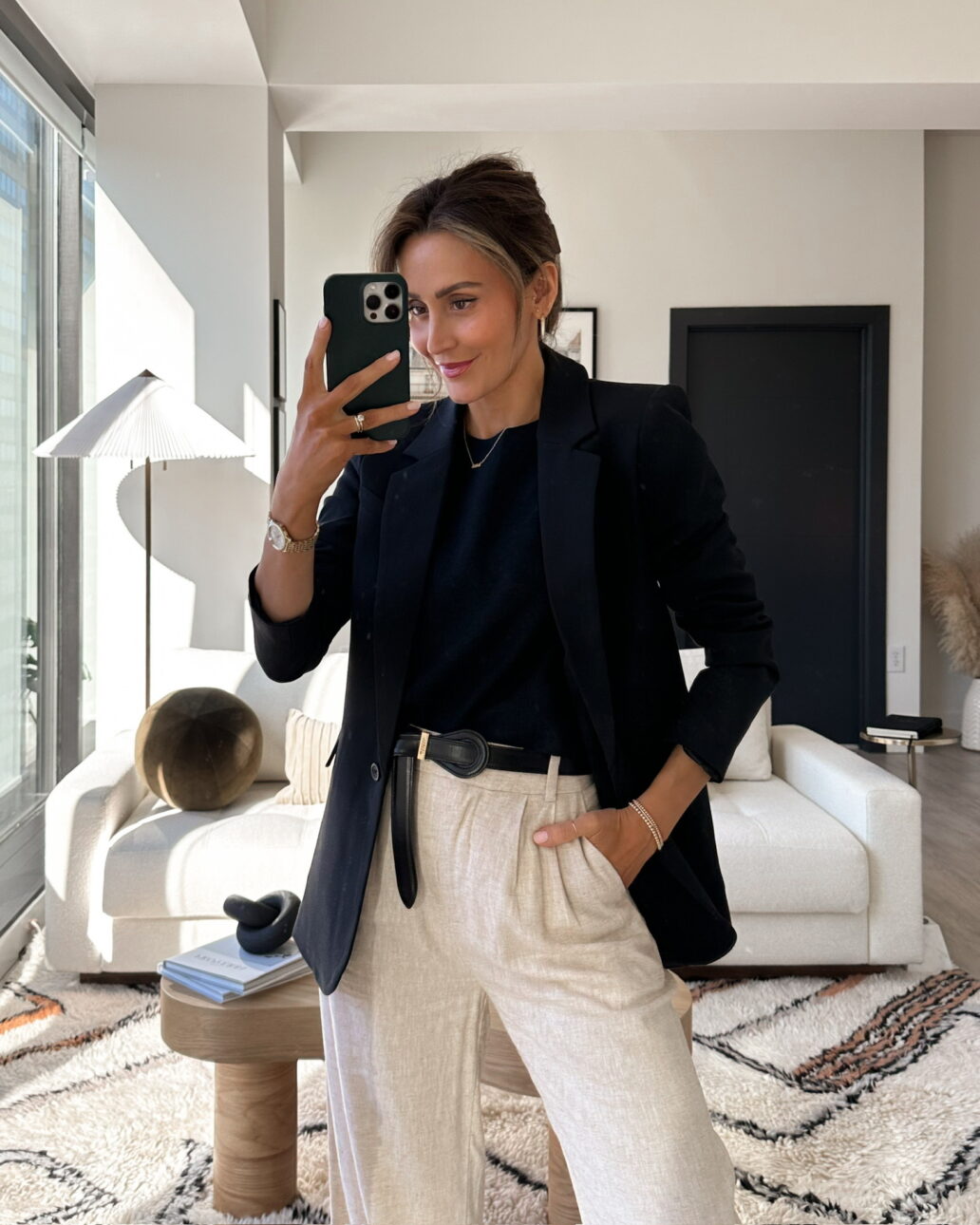 linen trouser outfit with a black tank top, black leather belt, black blazer, and matching black sandals