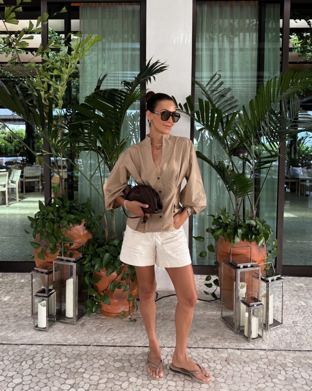 linen shorts outfit with cinched waist shirt and sunglasses