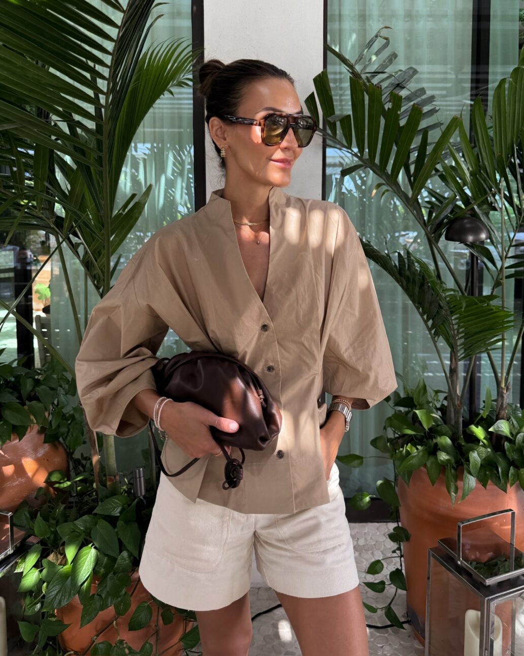 linen shorts outfit with cinched waist shirt and sunglasses