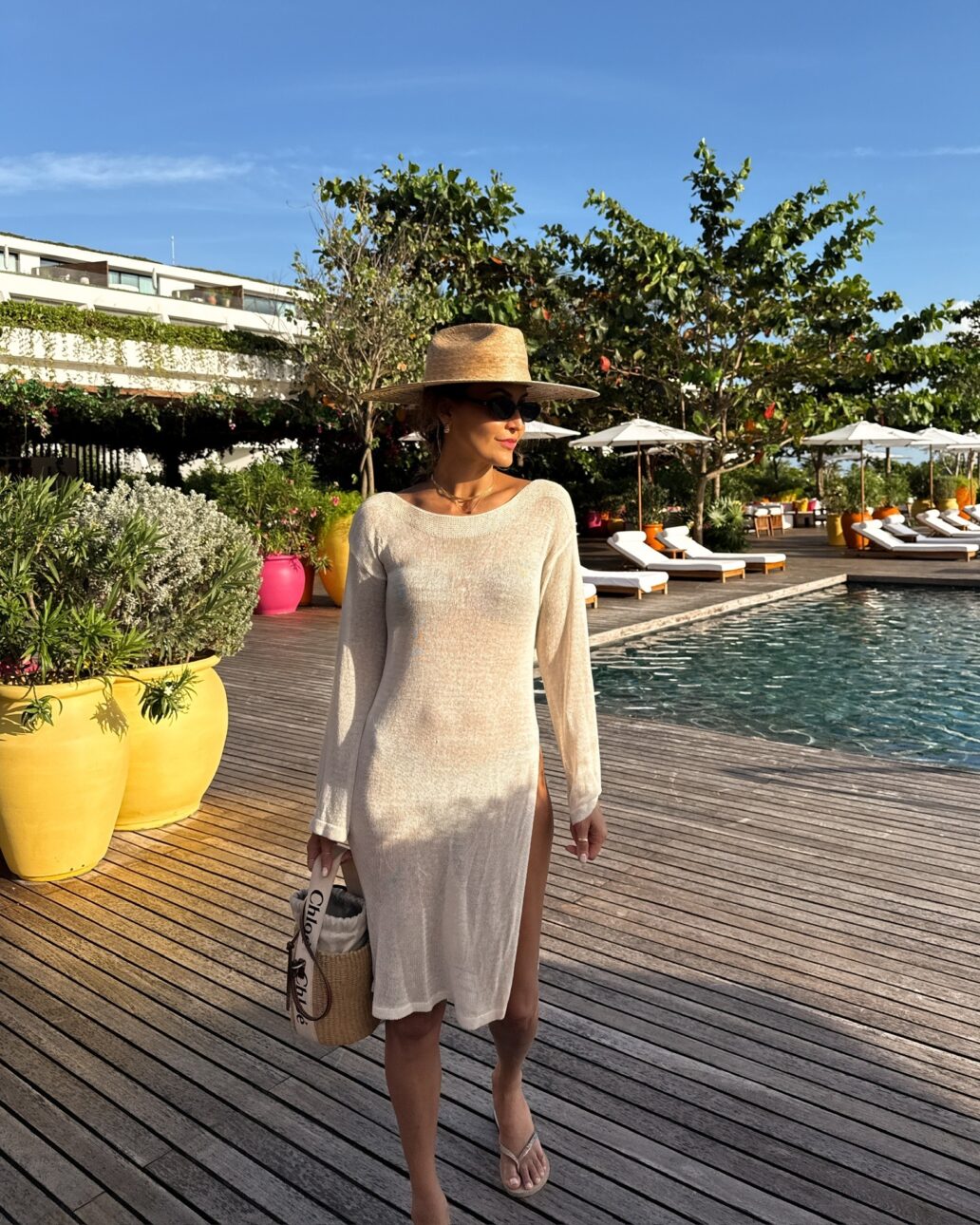 sheer cover-up dress with bikini, sun hat, sunglasses, and a straw basket bag