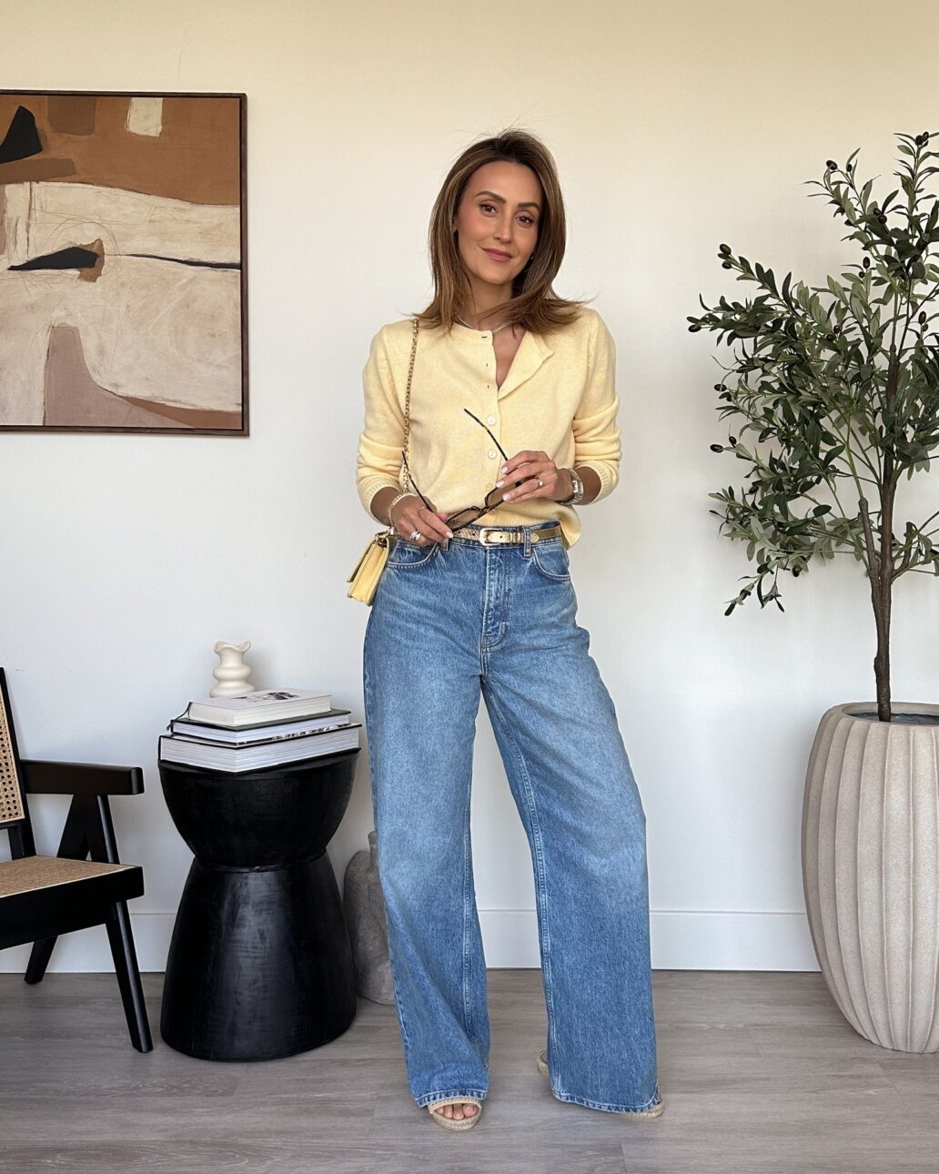 yellow cardigan with wide leg jeans and raffia slide sandals