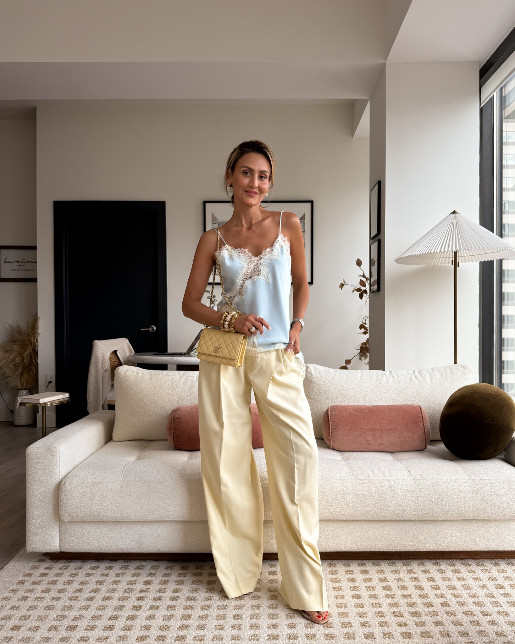 blue lace blouse, butter yellow pleated trousers, yellow mini channel bag, gold jewelry